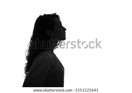 Silhouette portrait of a beautiful young girl with long hair isolated on white background