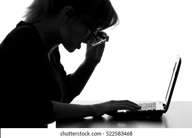 silhouette portrait of a young woman working on a netbook remotely on the Internet rose glasses from surprising of the seen information