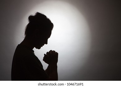 Silhouette Of Praying Woman