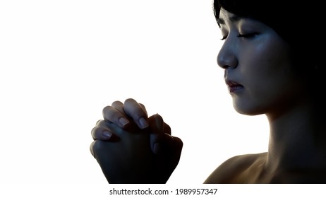 Silhouette Of Praying Young Asian Woman. Slow Motion.