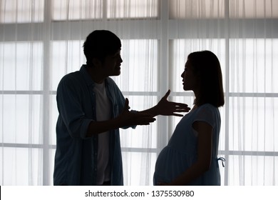 Silhouette Of Pregnant Couple Arguing And Quarreling At Home