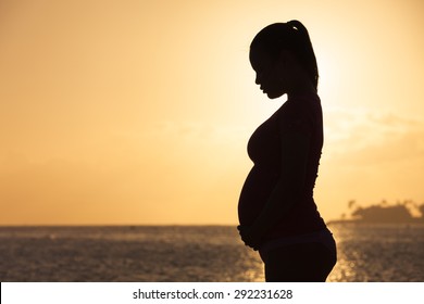 Silhouette of pregnant woman. 