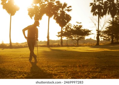 Silhouette Professional Golfer asian man swing and hitting golf ball practice at golf driving range and fairway in sunny morning day on club golf. Lifestyle and Sport Concept - Powered by Shutterstock