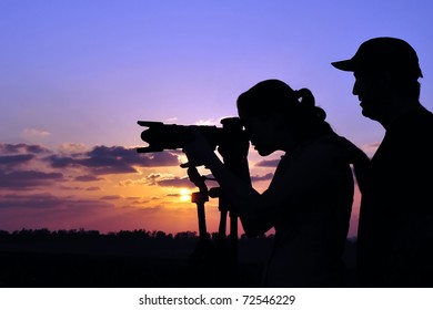 Silhouette Of A Professional Photographer Teaching A Young Woman Student Nature, Wildlife And Landscape Photography Outdoors During Sunset Sunrise.Real People. Copy Space