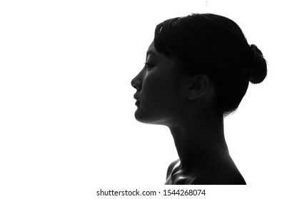 Silhouette Of Profile Of A Young Asian Girl.