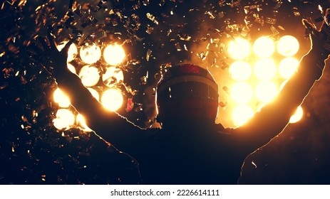 Silhouette of race car driver celebrating the win in a race against bright stadium lights. 100 FPS slow motion shot - Shutterstock ID 2226614111