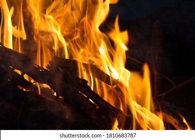 Silhouette Of A Red Hot Orange Fire Flame Rising Warm Heat Above A Burning Pile Of Cold Winter Holiday Season Yule Log Sticks In The Night Time Home Fire Place For Warmth