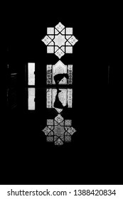 silhouette and reflection of people praying at the mosque during Ramadhan
