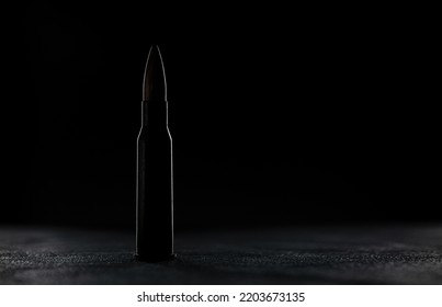 Silhouette Of Rifle Bullet Long Cartridge On Black Background. Army Or Hunting Weapon Shot Object, Violence And Danger Symbol.