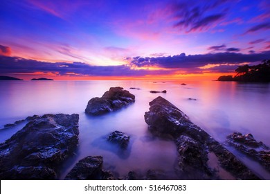 silhouette of rocks on the beach, Seascape in sunset sky and sea at Tarn Khu beach - Trat ,Thailand.