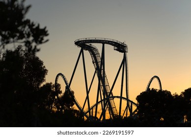 Silhouette of a roller coaster after a orange sunset. - Powered by Shutterstock