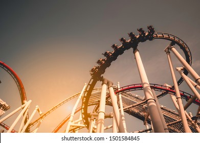 Silhouette of a rollercoaster in an amusement park.It reflects the investment that has fluctuations all the time.And high risk