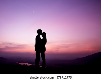silhouette Romantic couple lovers  hug and  kiss  at colorful sunset on background  
.love concept
