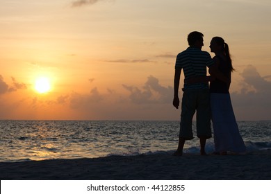 Silhouette Of Romantic Couple On Tropical Beach At Sunset