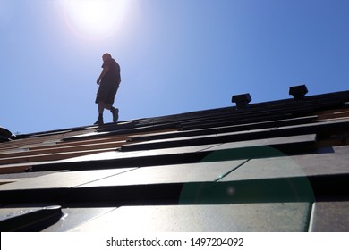 Silhouette Of A Roofer In The Backlight