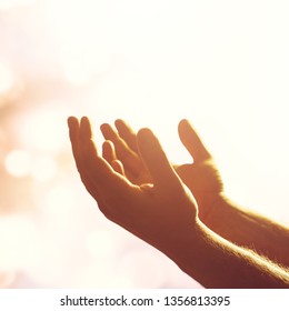 Silhouette Rosary Against Cross In Hand