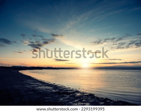 Silhouette of a rough coastline at sunrise. Warm and cool color. Nobody. Stunning nature scene. Galway bay, Ireland.