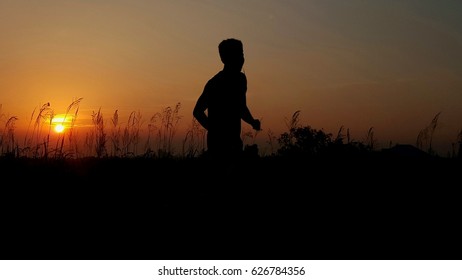 Silhouette a running man while the sunset.  