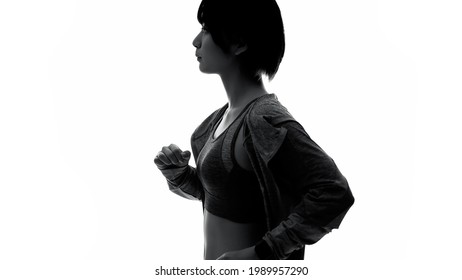 Silhouette Of Running Young Asian Woman. Slow Motion.