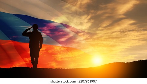 Silhouette Of Russian Soldier In Uniforms On Background Of Sunset Sky With The Russian Flag. Military Recruitment Concept.