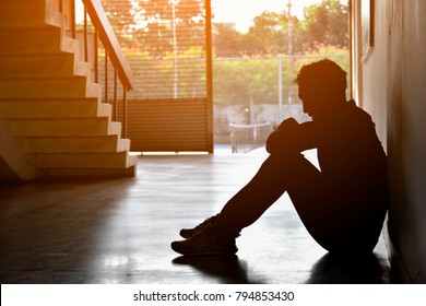 Silhouette of Sad Depressed Insomnia Man.Sitting Against Sunset. The Protection and Treatment of Major Depressive Disorder Problem Concept.