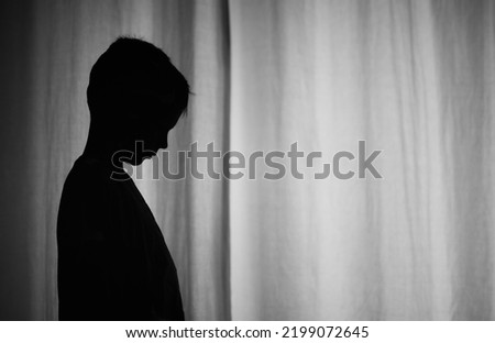 Silhouette of sad little boy 
