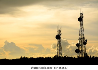 silhouette satellite dish telecom network at sunset communication technology network