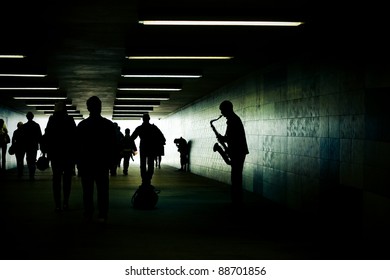 Silhouette Of A Saxophonist In The Subway Tunnel