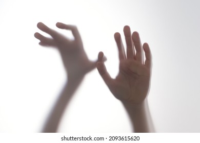 Silhouette Scared Boy Stand Behind Glass Door. Kid Showing Two Hands. Background Representing Dangerous, Fear, Help, Haunting, Horror And Panic. Teen Problems, Negative Emotions Concept.