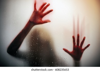 Silhouette  Scared Girl Hand With Red Blood Behind Glass Door , Horror Background 