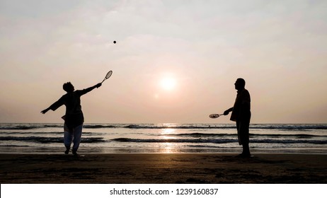 Silhouette of senior couple playing tai chi ballon ball at the beach. Active leisure of aged family outdoor. - Powered by Shutterstock