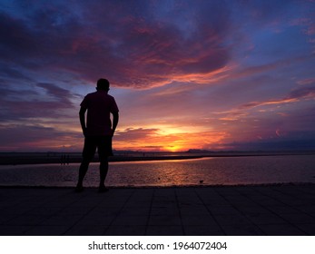 Silhouette Of Senior Man Standing Alone On The Coast In Front Of The Sea In The Evening, Man Standing And Watching Sunset Over The Sea At Samui Thailand