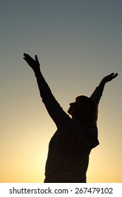 The Silhouette Of A Senior Woman Reaching Up To The Sky, Awaiting A Better Future And Thankful For The Day. Hope/gratitude/health Concept.