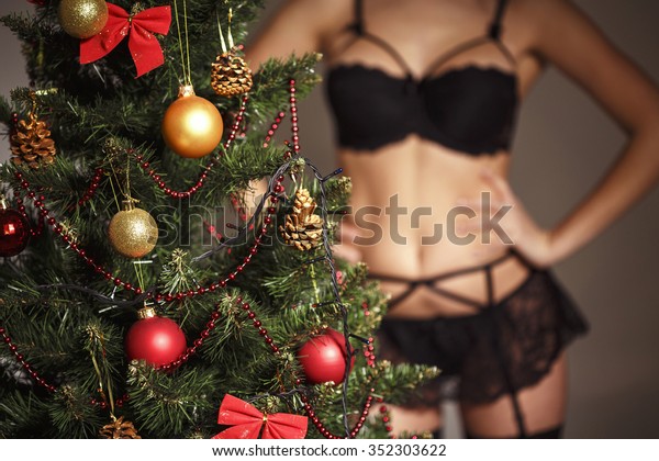 silhouette sexy women in lingerie. Christmas tree in the foreground