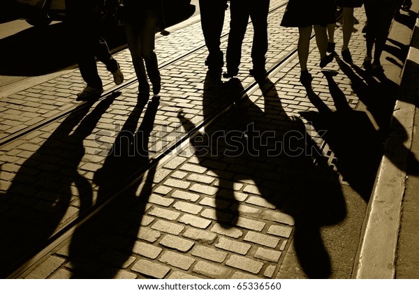Silhouette and shadows of people walking,\
brick pavement and street car tracks, focus on shadows, Fisherman\'s\
Wharf, San Francisco,\
California,