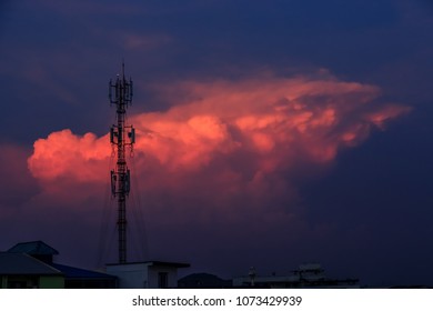 Silhouette signal antenna tower at beautiful sunset sky background
