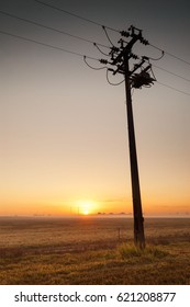 Silhouette Of Simple Pylon And Power Lines At Dawn. Darwin, Australia