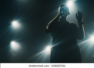 A Silhouette Of A Singer On The Stage. Good-looking Background, Bright Stage Lights. 