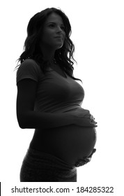 Silhouette of the smiling pregnant woman isolated on white