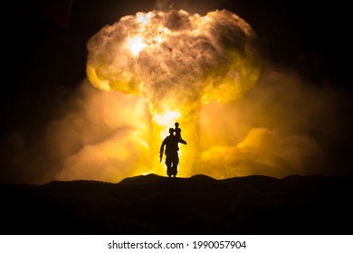 Silhouette Soldier Carrying Little Boy On His Shoulder From Fire. Rescue Savior Concept. Man Moving Out With Little Boy From Burned Out City Destroyed In War. Selective Focus