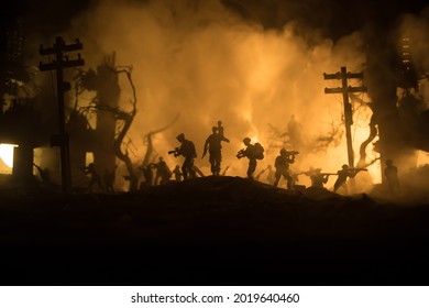 Silhouette Soldier Carrying Little Boy On His Shoulder From Fire. Rescue Savior Concept. Man Moving Out With Little Boy From Burned Out City Destroyed In War. Selective Focus