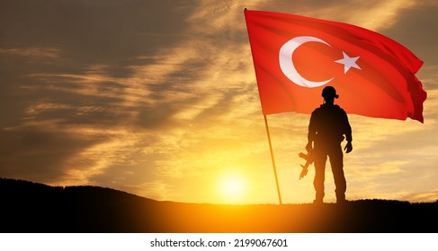 Silhouette Of Soldier With Turkey Flag On Background Of Sunset. Concept Of Crisis Of War And Political Conflicts Between Nations. Greeting Card For Turkish Armed Forces Day, Victory Day.