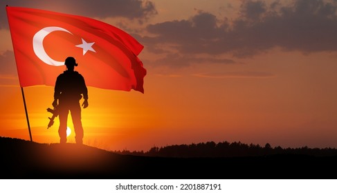 Silhouette Of Soldier With Turkey Flag On Background Of Sunset. Concept Of Crisis Of War And Political Conflicts Between Nations. Greeting Card For Turkish Armed Forces Day, Victory Day.