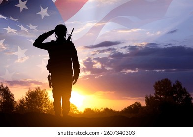 Silhouette of a soldier with USA flag against the sunset. Memorial Day, Veterans Day