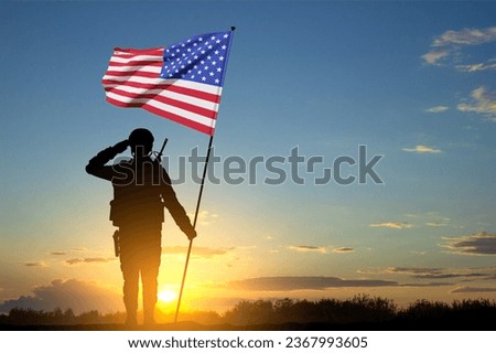 Silhouette of soldier with USA flag against the sunset. Greeting card for Veterans Day, Memorial Day, Independence Day