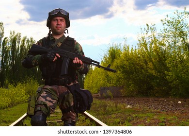 The Silhouette Of A Soldier Walking By Rail In The Overexposed Backlight Of The Sun. Lifestyle