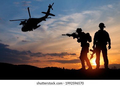 Silhouette of a soldiers and helicopter on the background of sunset. Concept - protection, patriotism, honor. Armed forces of Turkey, Israel, Egypt and other countries.