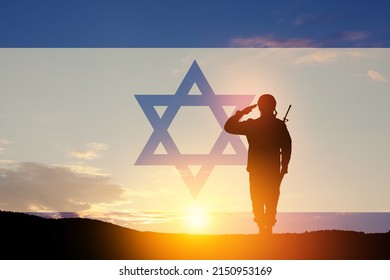 Silhouette of soldiers saluting against the sunrise in the desert and Israel flag. Concept - armed forces of Israel.