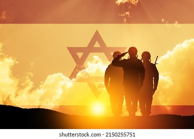 Silhouette of soliders saluting against the sunrise in the desert and Israel flag.