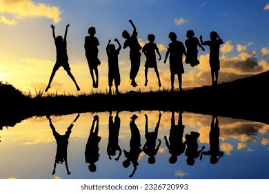 silhouette of some children in sunset with reflection - Powered by Shutterstock